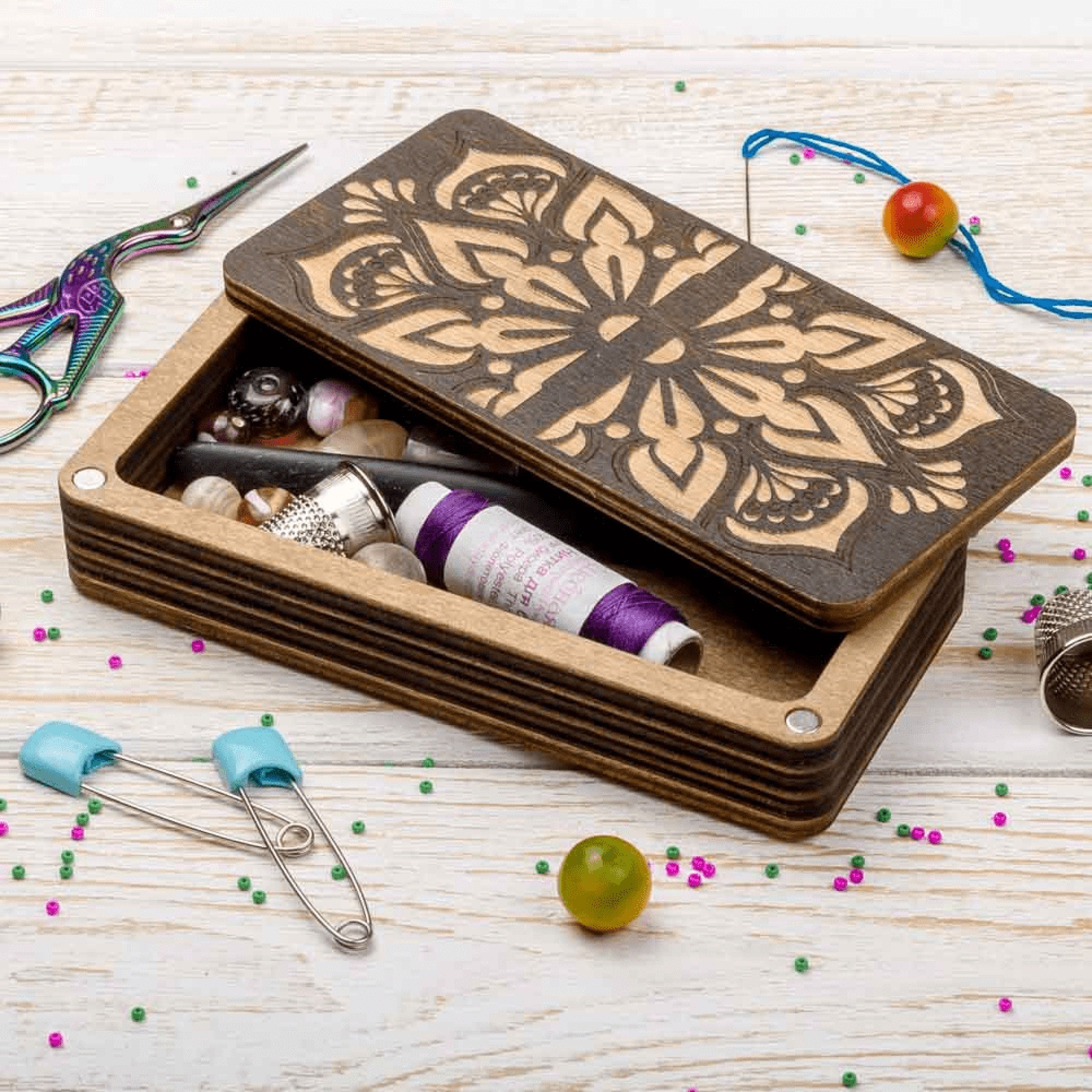 a wooden box filled with lots of craft supplies